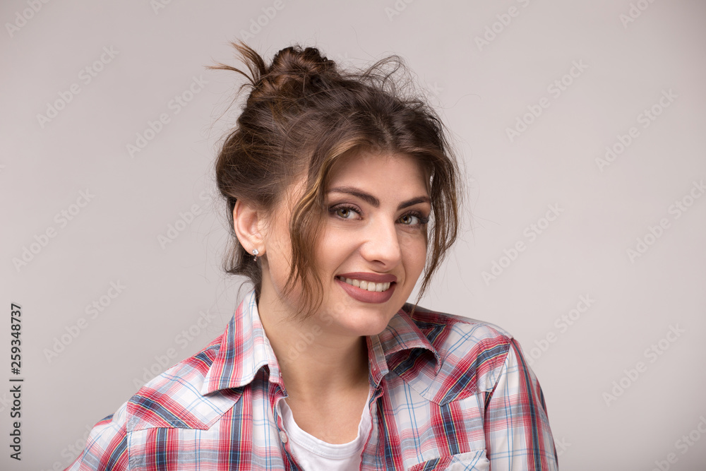 Beautiful caucasian woman with loose curly hair smiling and looking at camera. Beautiful caucasian woman with loose curly hair smiling and looking at camera.