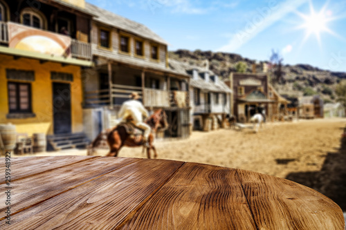Wooden old table of free space for your decoration and Wild West background. 
