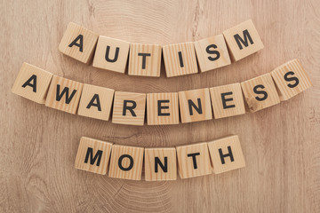 top view of autism awareness month words made of wooden cubes
