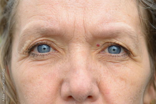 Close-up of blue eyes of middle age woman