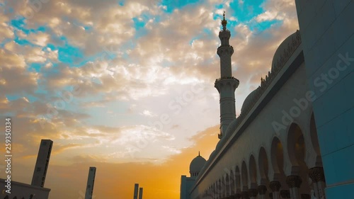 A Young Girl Walks Into a Mosque at Sunset. Travel to the East photo