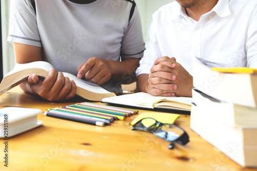 Students helps friend teaching and learning subject additional in library. Education concept.