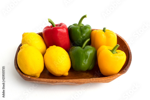 colerful bell peppers and lemon on white background photo