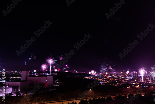 Long exposure of fireworks during new years eve over Reykjavik city in Iceland