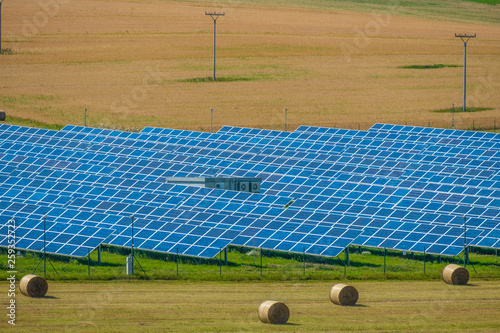 Aerial view to solar power plant. Industrial background on renewable resources theme. photo