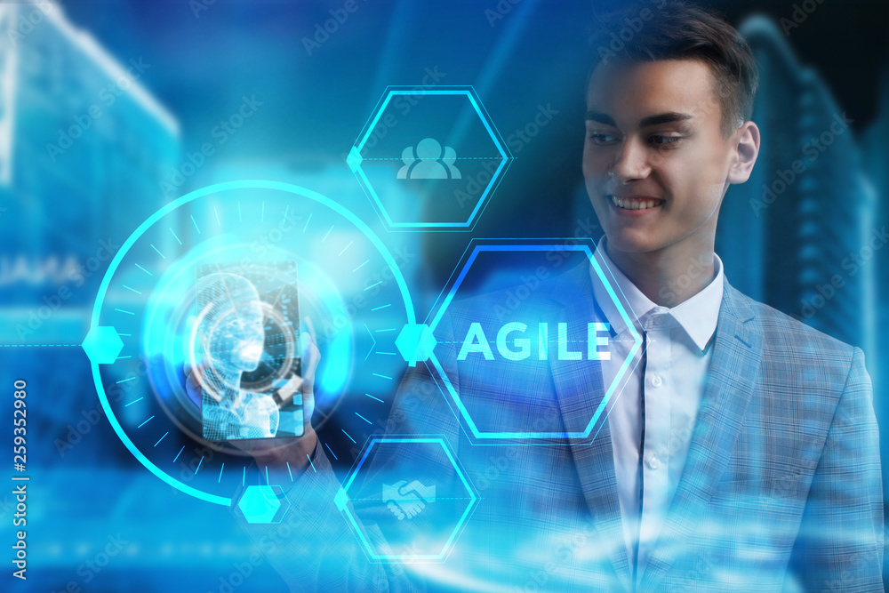 The concept of business, technology, the Internet and the network. A young entrepreneur working on a virtual screen of the future and sees the inscription: Agile The concept of business, technology, the Internet and the network. A young entrepreneur working on a virtual screen of the future and sees the inscription: Agile