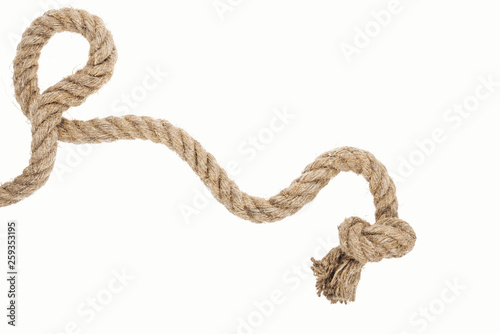 thick jute and brown rope with knot isolated on white photo