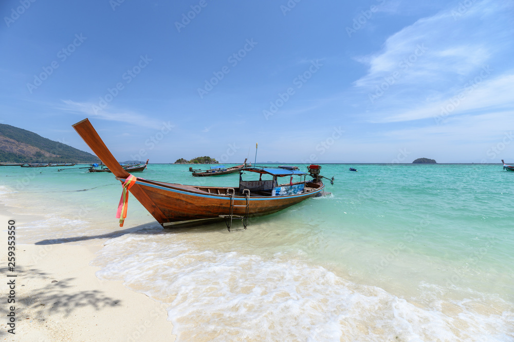 Beautiful crystal tropical sea with wooden boat at lipe