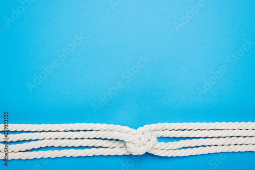 nautical white ropes with sailor knot isolated on blue