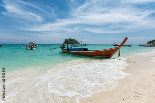 Beautiful crystal tropical sea with wooden boat at lipe
