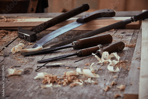 Vintage chisels, rasp handsaw and hammer