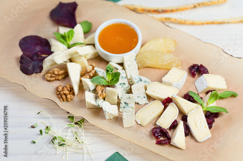 Various types of cheese composition on wooden board