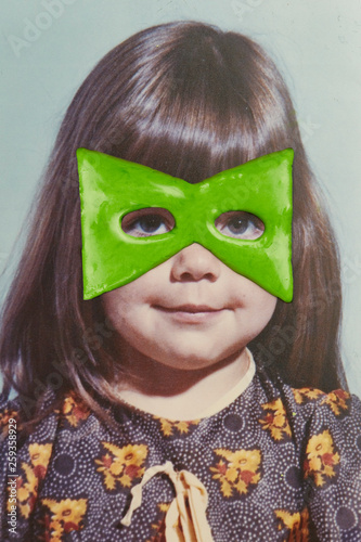Girl with green superhero mask