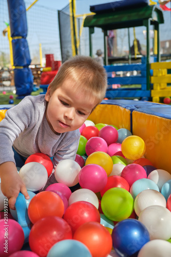 Boy is playing in the ball pool