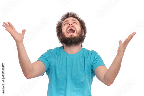 Portrait of caucasian crazy bearded Man with funny Curly Hair - saying prayers, isolated on white background. Religious image - Guy praying and praising God. photo