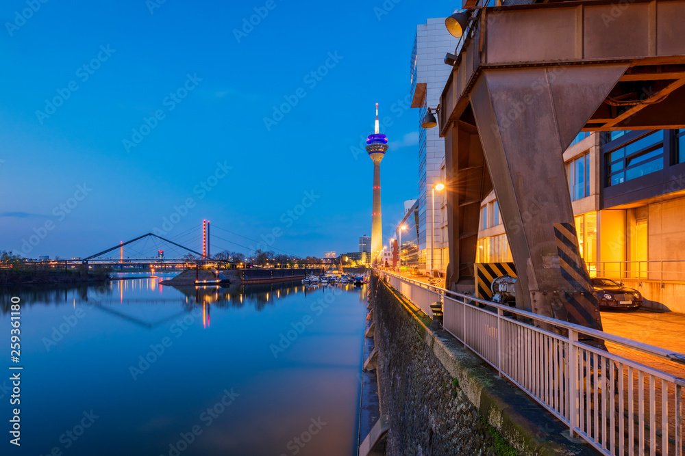 Harbor in Düsseldorf Germany with famous Rheinturm Tower at Dusk