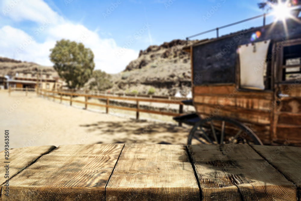 Wooden old table of free space and Wild West background 