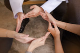 In selective focus of Human hands touch together,making circle,sign and symbol of trust,unity,collaborator,teamwork