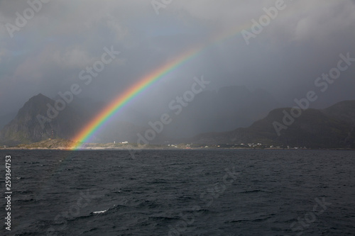 Colorful Rainbow in the Arctic ocean  Reine  Lofoten islands  Norway.