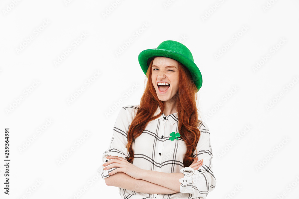 Happy young redheaded girl wearing green hat