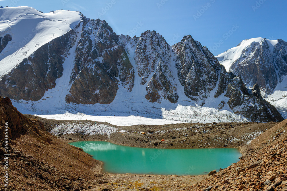 Beautiful turquoise waters of the lake with snow-covered peaks