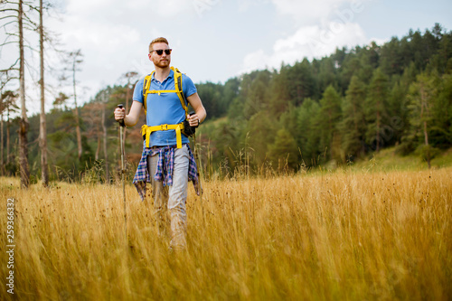 Young hiker enjoys a sunny day on the mountain