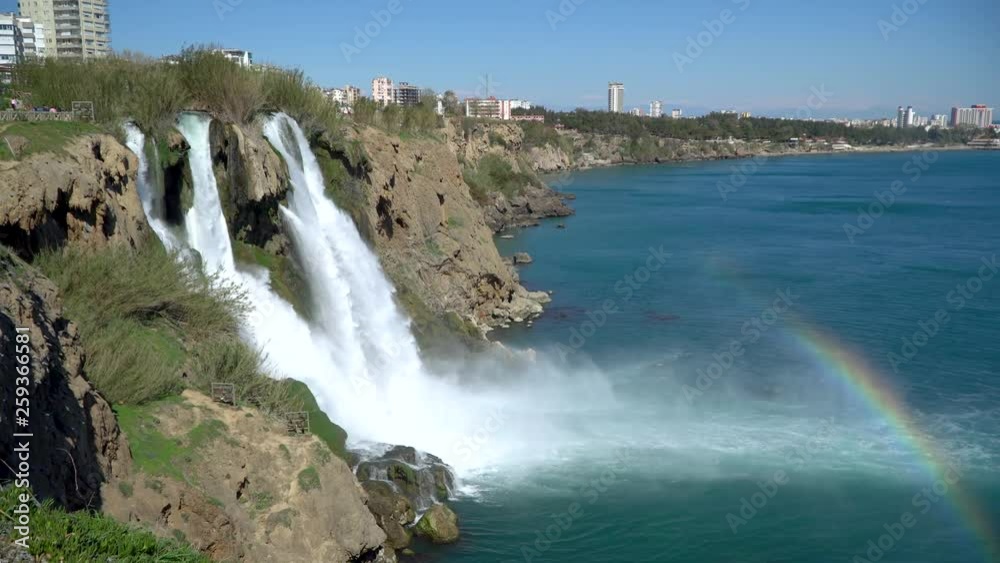Antalya, Turkey - March 2019: Waterfall Duden falling into the Mediterranean sea with rainbow scene Antalya, Turkey - March 2019: Waterfall Duden falling into the Mediterranean sea with rainbow scene