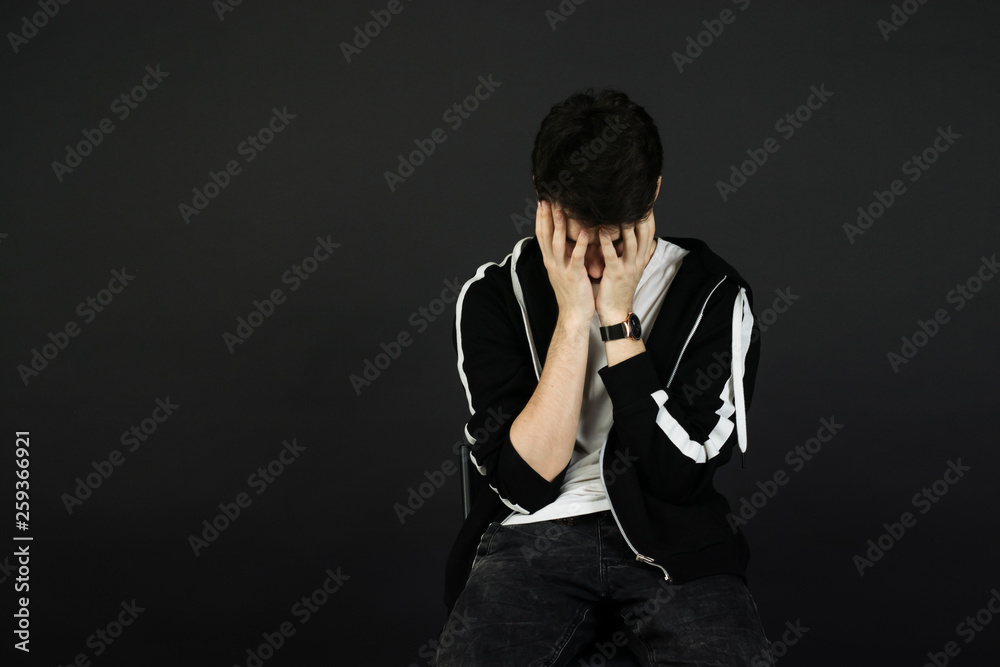 handsome young man posing on black background handsome young man posing on black background