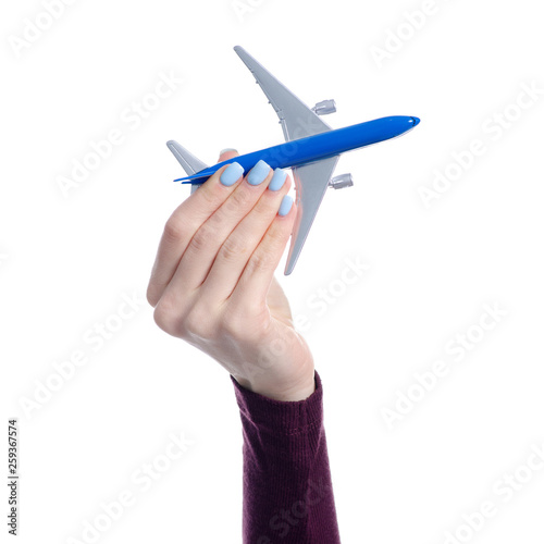 Small airplane in hand on white backgriund isolation