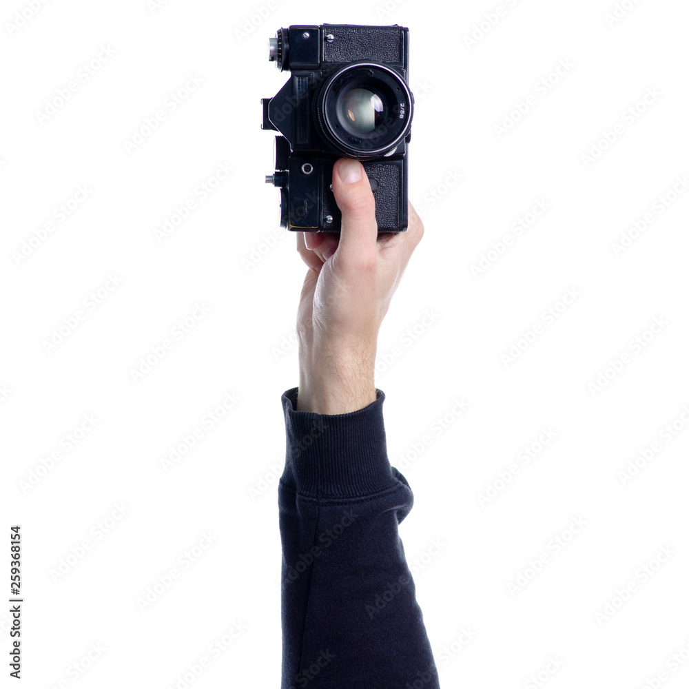 Old Photo camera in hand on white background isolation Old Photo camera in hand on white background isolation