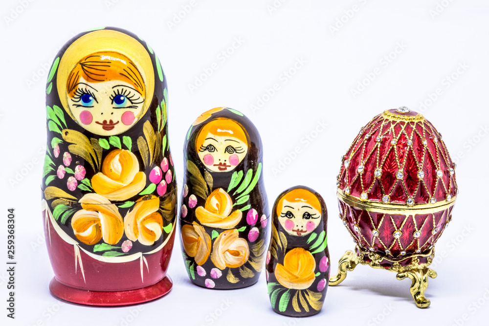 Matryoshka family. Matrioska art Russian doll and Russian souvenir, egg casket copy of Faberge on a White background Matryoshka family. Matrioska art Russian doll and Russian souvenir, egg casket copy of Faberge on a White background