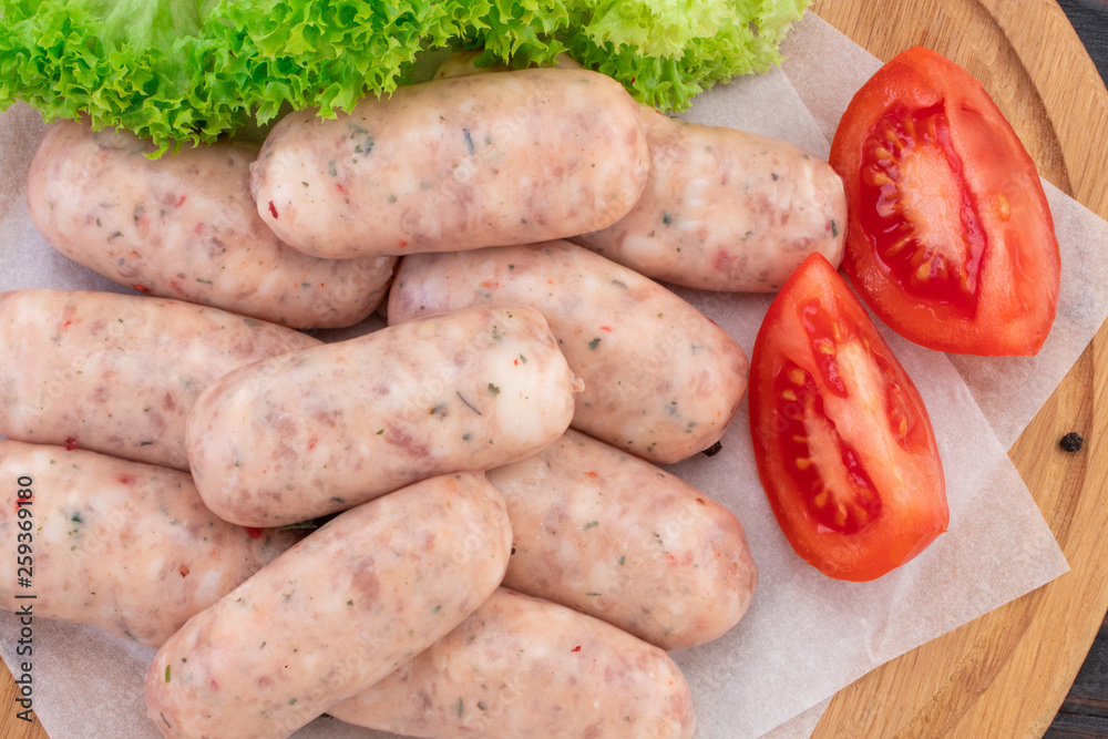 Fresh raw sausage on the wooden background, top view Fresh raw sausage on the wooden background, top view