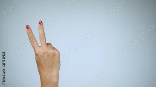 Wallpaper Mural Female hand with beautiful red glossy manicure counting from 1 to five with fingers. 4k video footage. Torontodigital.ca