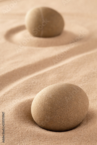 two round stones in sand. Japanese rock garden stands for purity and harmony.
