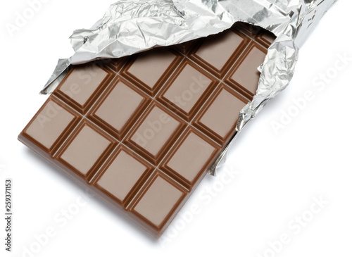 milk chocolate bar covered with foil isolated on white background with clipping path photo