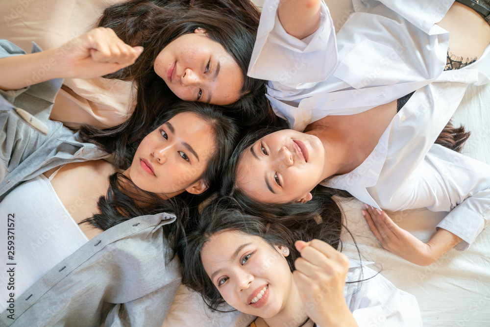 Fototapeta premium Group of beautiful pretty asian women friend on cozy bed
