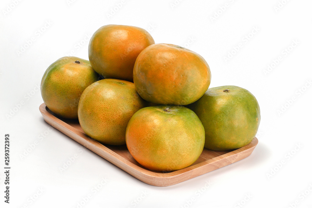 Orange in wooden plate. Orange honeydew Thai fruit isolated on white background