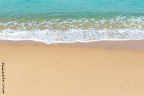 Soft wave of sea and sandy beach background.
