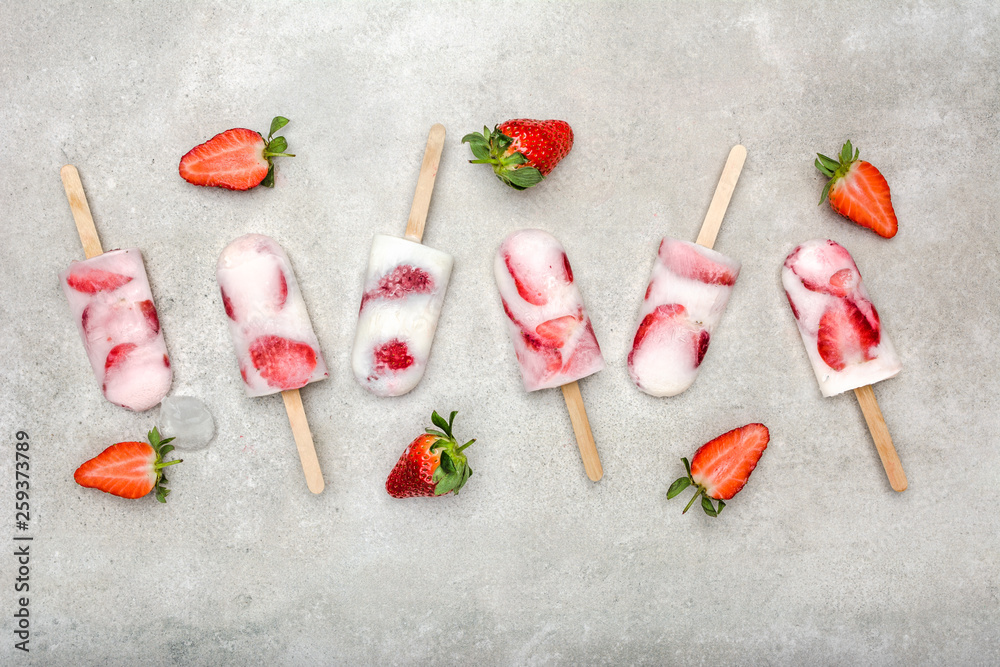 Fresh strawberry popsicles with yogurt and strawberries. Ice pops, flat lay, top view Fresh strawberry popsicles with yogurt and strawberries. Ice pops, flat lay, top view