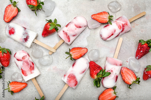 Fototapeta Naklejka Na Ścianę i Meble -  Fruit popsicle with frozen strawberry and yogurt, ice cream on stick