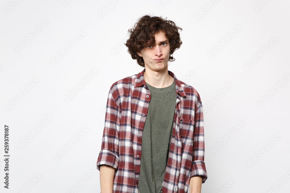 Portrait of perplexed bewildered young man in casual clothes standing and looking camera isolated on white wall background in studio. People sincere emotions, lifestyle concept. Mock up copy space. Portrait of perplexed bewildered young man in casual clothes standing and looking camera isolated on white wall background in studio. People sincere emotions, lifestyle concept. Mock up copy space.
