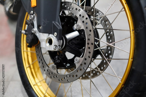 Disc brake with wheel hub on motorbike. Close up of front disc brake on motorcycle. Motorcycle car care and maintenance concepts. - Selective focus