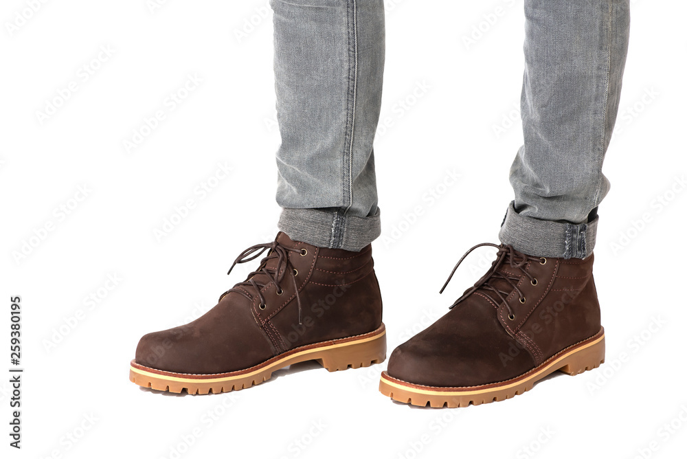 Fashion men’s legs in jeans and brown boots leather for man collection isolated on a white background. Clipping path