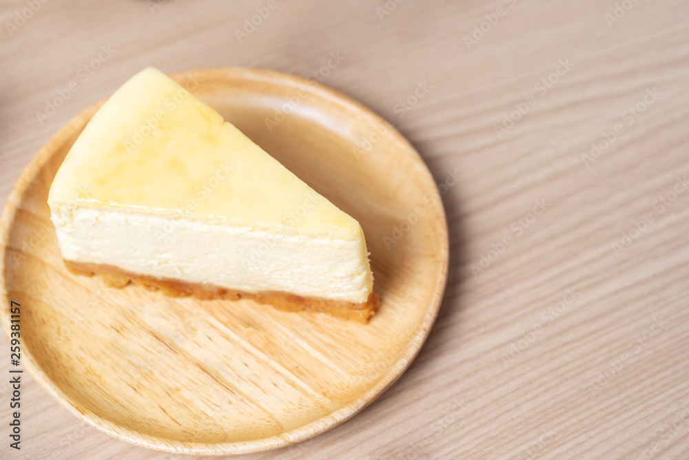 Homemade Cheese cake or butter cake put on wooden plate or dish and place on table.