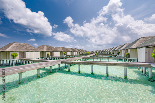 Luxury resort in Maldives, water villas and beautiful cloudy sky. Perfect travel and tourism background
