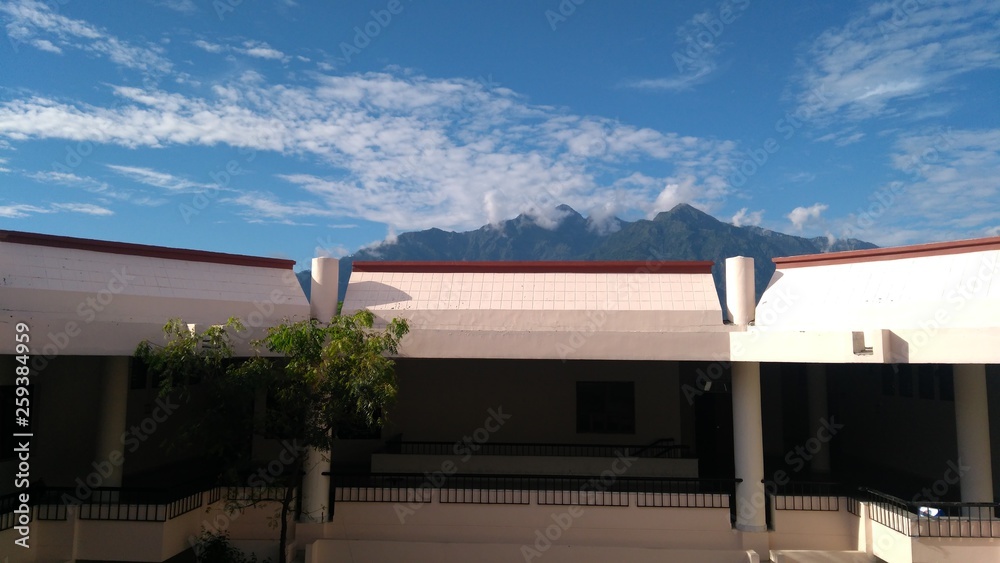 Fototapeta premium clouds and mountains over building