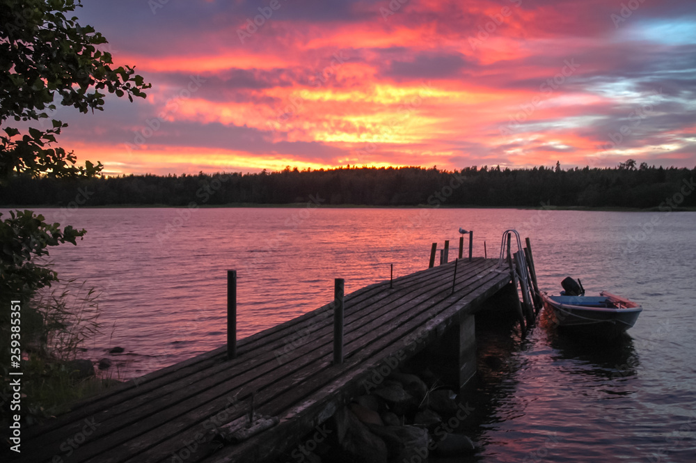 Fototapeta premium Evening ambiance at Golf of Finland. Boat and seagul on jetty.
