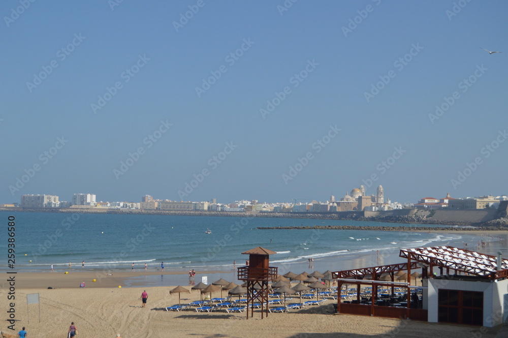 Obraz premium Views Of The Historic Center Of Cadiz From The Beach Of Santa Maria Del Mar. Nature, Architecture, History, Street Photography. July 10, 2014. Cadiz, Spain.