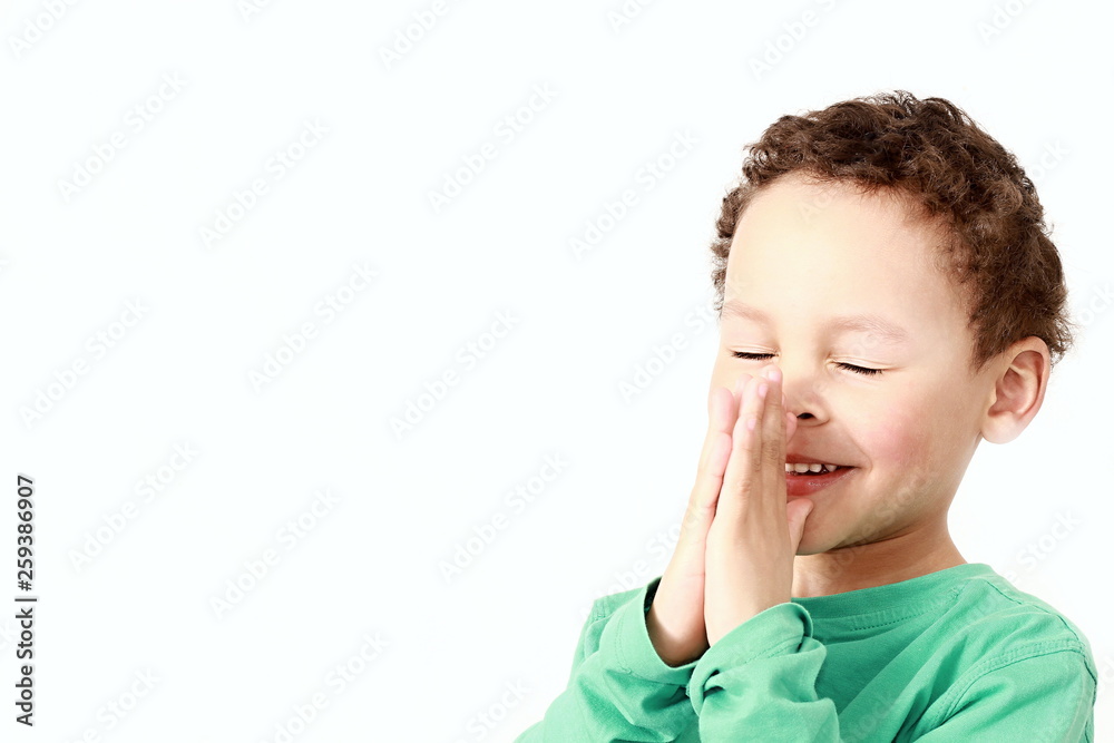 little boy praying to God with hands held together little boy praying to God with hands held together