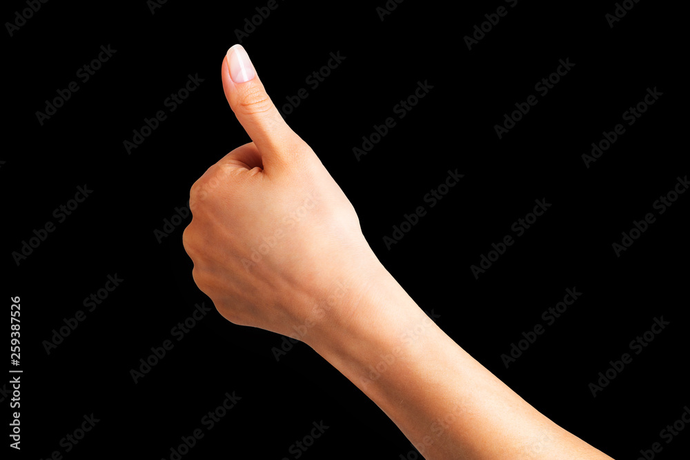 Woman holding hand in gesture of like sign, giving thumb up